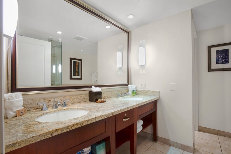 Double vanity bathroom with granite countertops and soft ambient lighting elegance.