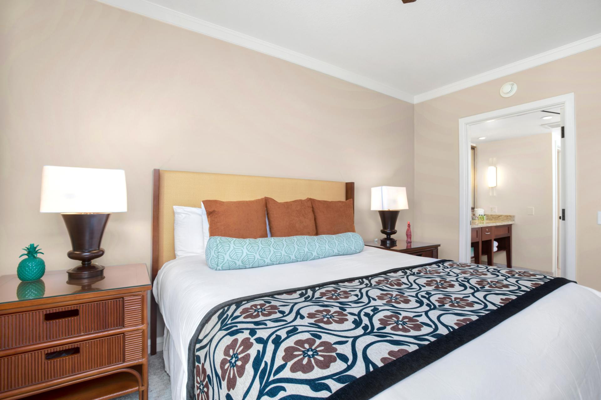 Tranquil bedroom retreat with ensuite access and charming tropical touches.