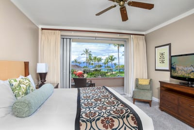 Relaxing bedroom sanctuary with lanai and breathtaking oceanfront palm views. HKK-201