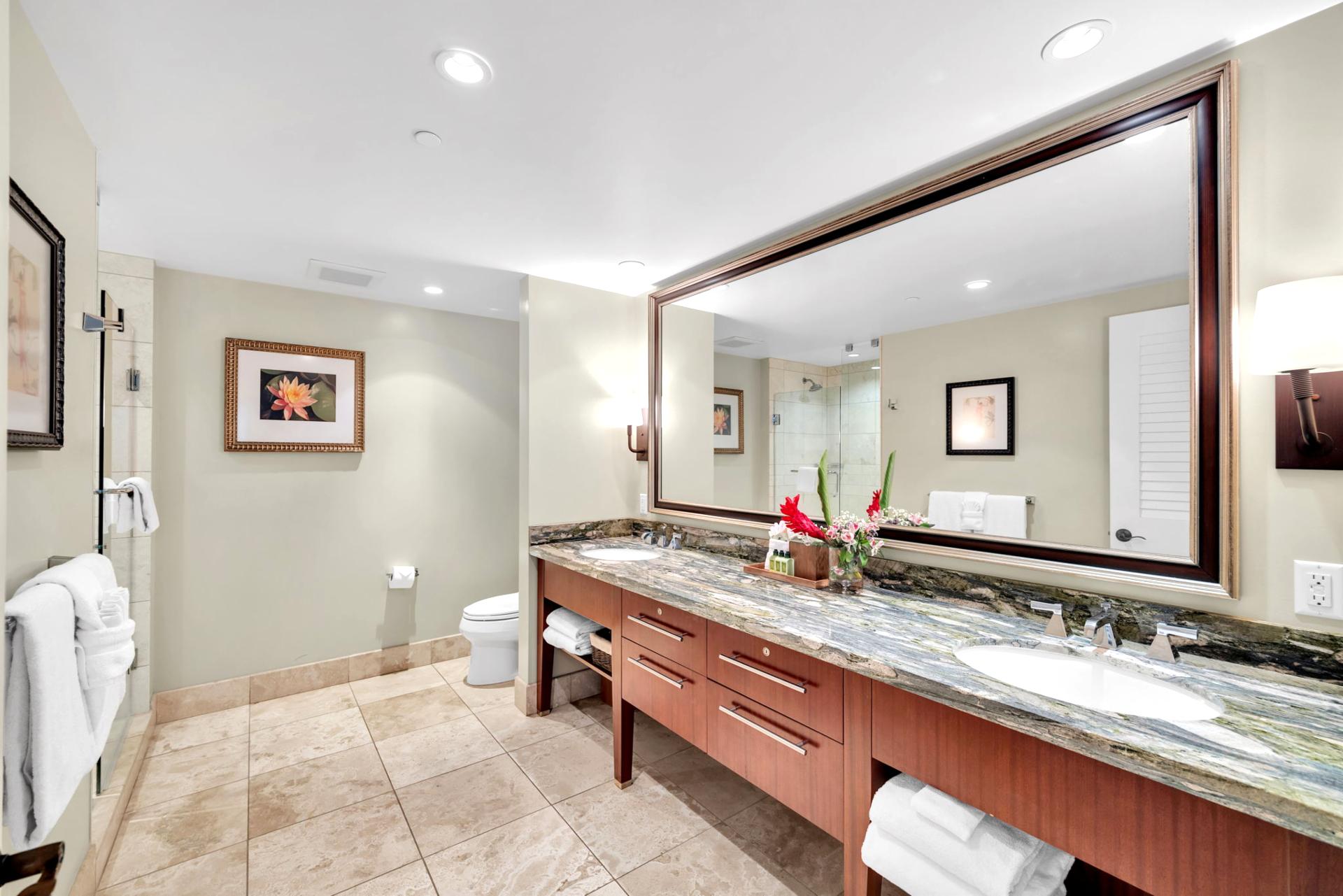 The third bathroom features a glass walk in shower and a double vanity