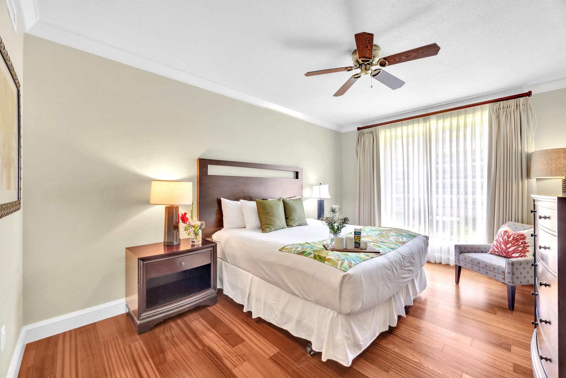The second guest bedroom features a comfortable king size bed and soft island decor