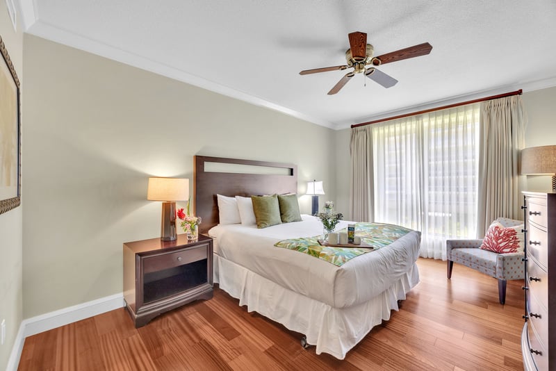 The second guest bedroom features a comfortable king size bed and soft island decor