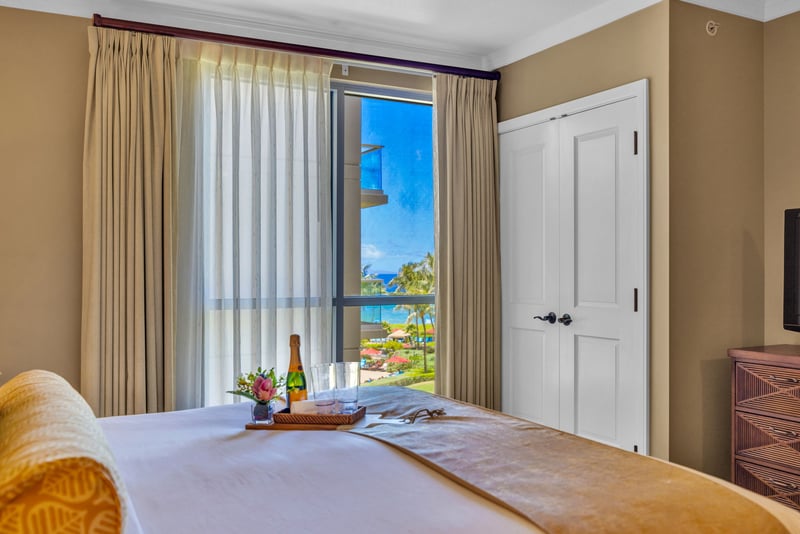 The guest bedroom features peekaboo ocean views
