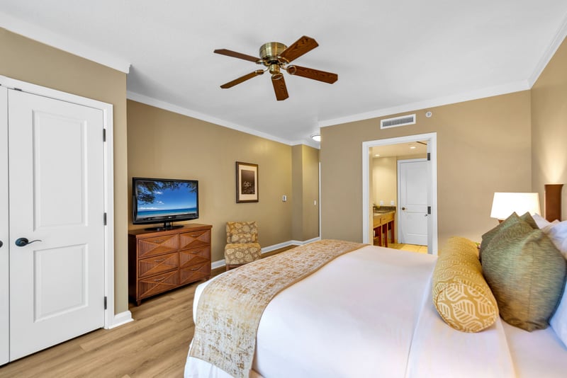 The relaxing guest bedroom features island decor and an ensuite bath
