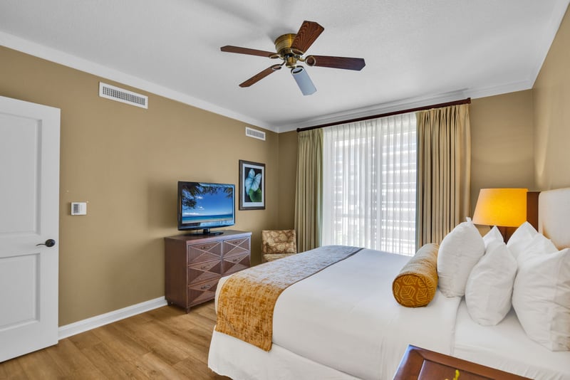The spacious master bed with a plush, comfortable king size bed