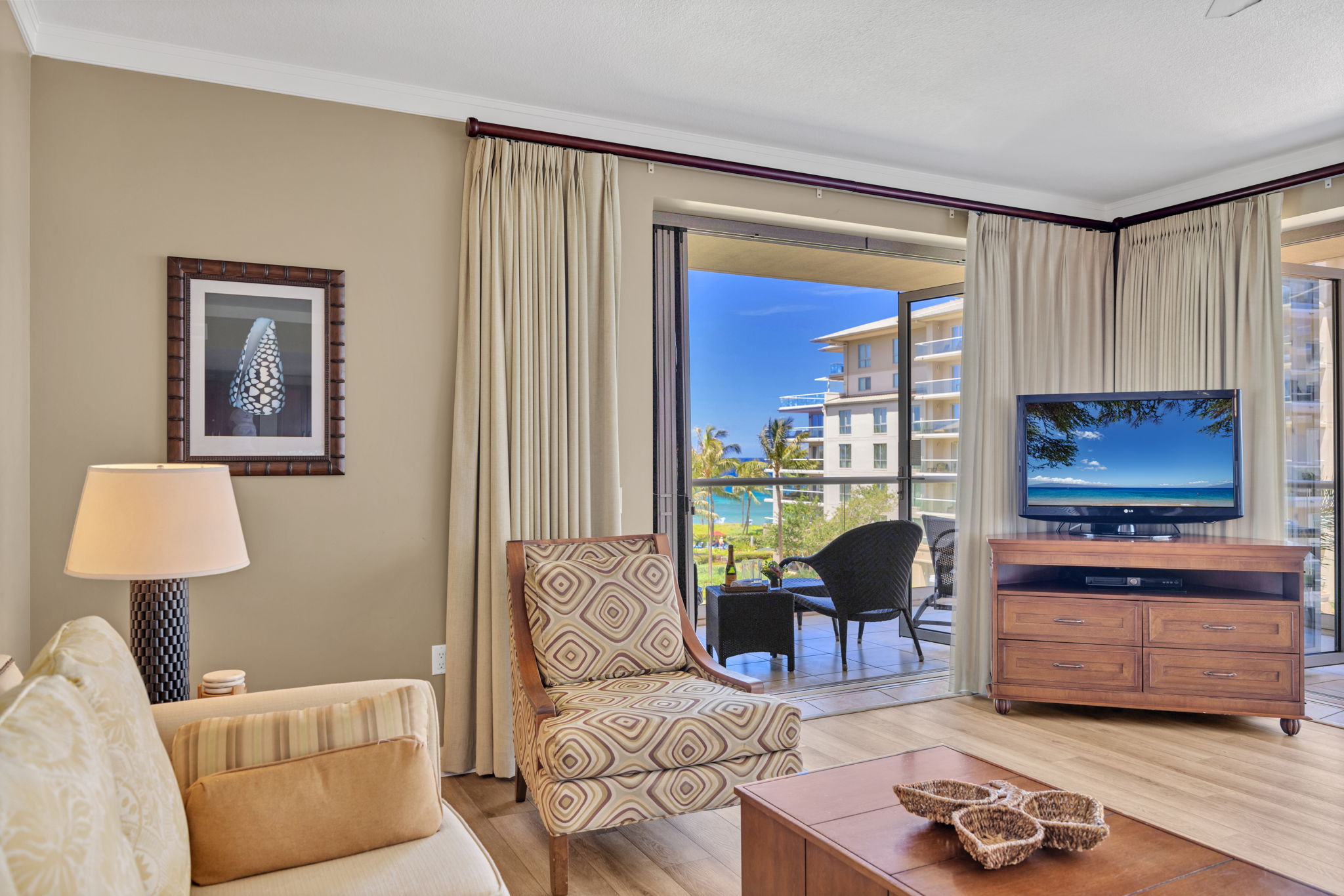 The comfortable living room features access to the lanai and island charm