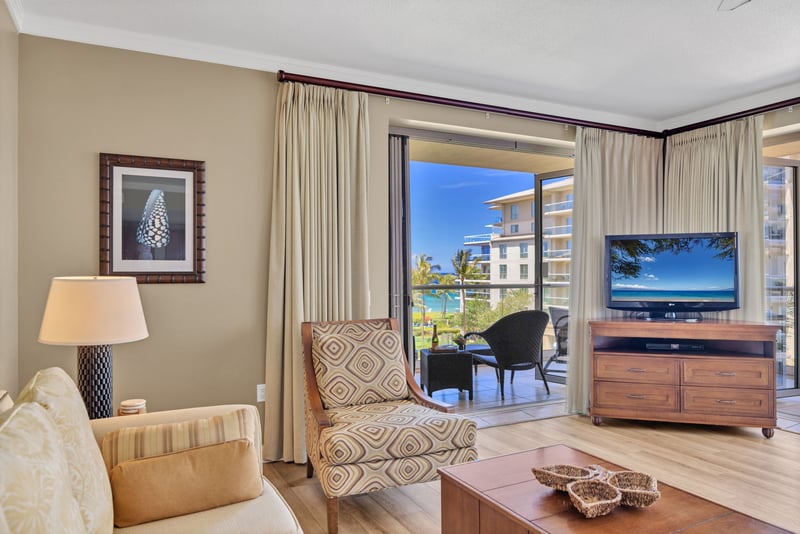 The comfortable living room features access to the lanai and island charm