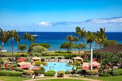 Relaxing by the pool with ocean breeze and sunshine bliss.