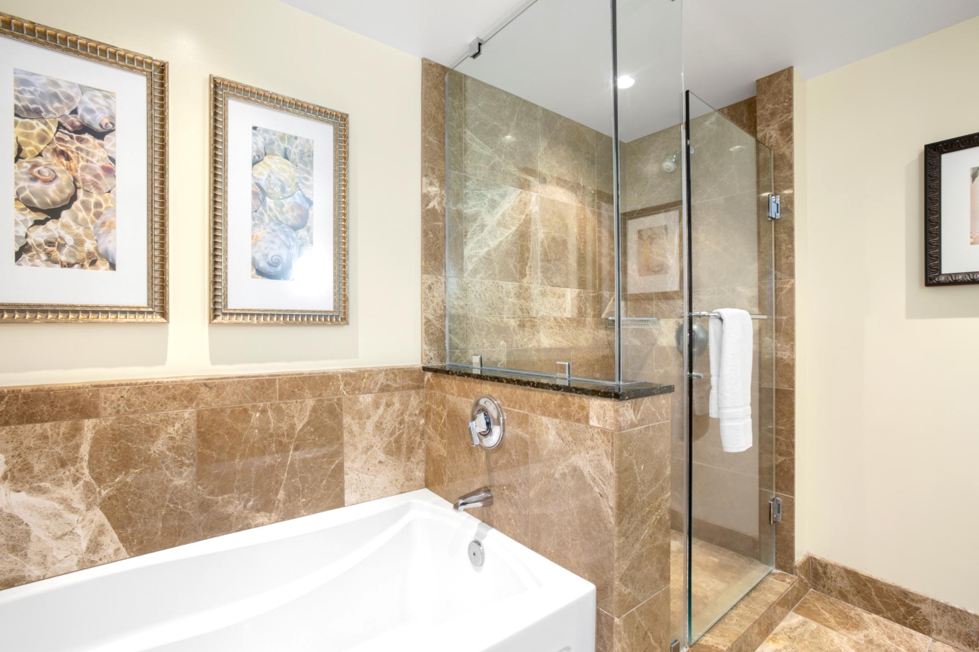 Refresh in style with a glass-door shower, warm tile, and calming color palette that soothes the senses