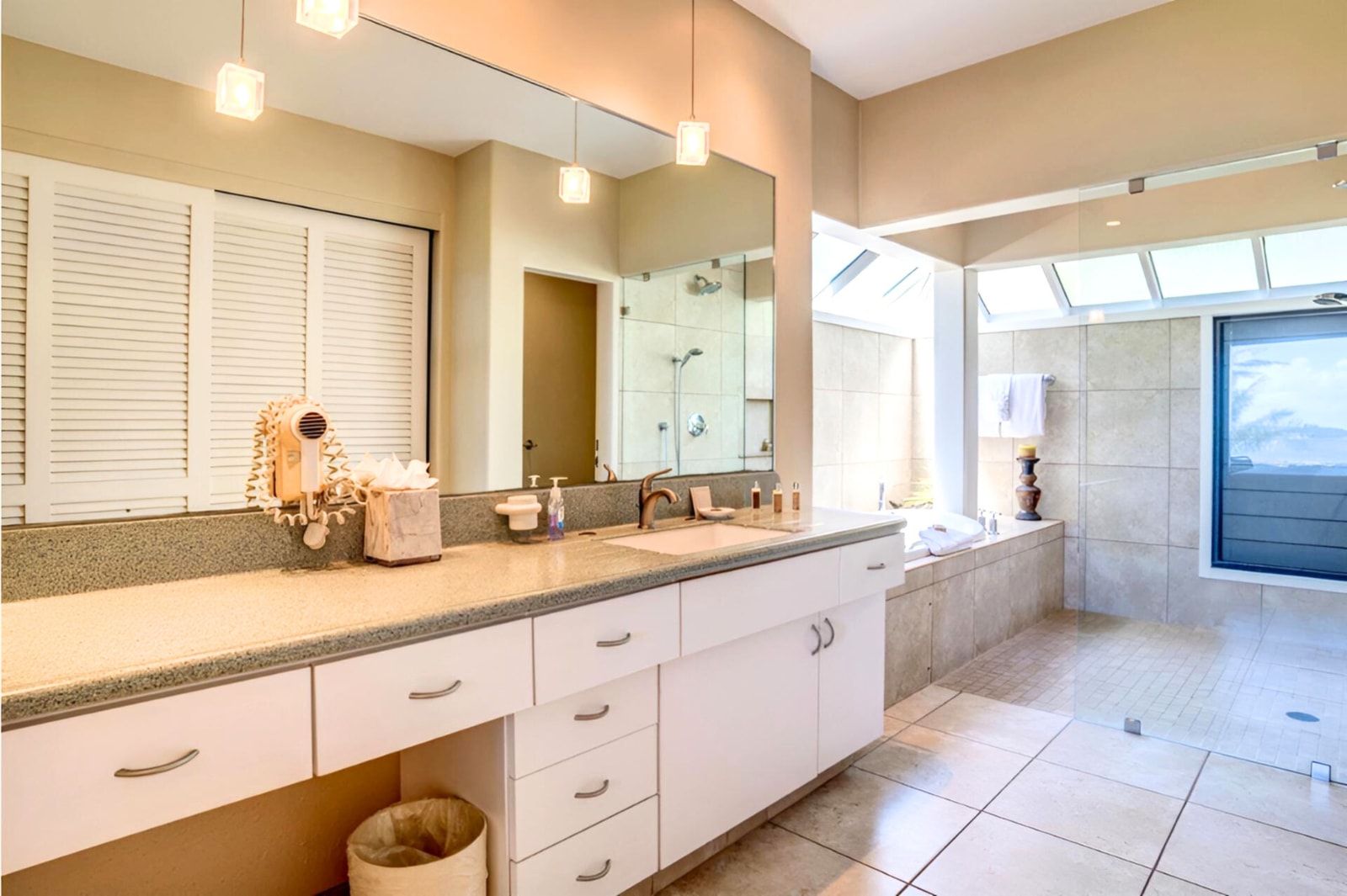 Enjoy seamless design and comfort with a frameless glass shower, elegant vanity, and tranquil ambiance throughout     KBV-16G4