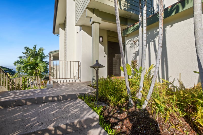 Framed by palms and island flora, this serene entrance welcomes you to a peaceful Kapalua escape like no other