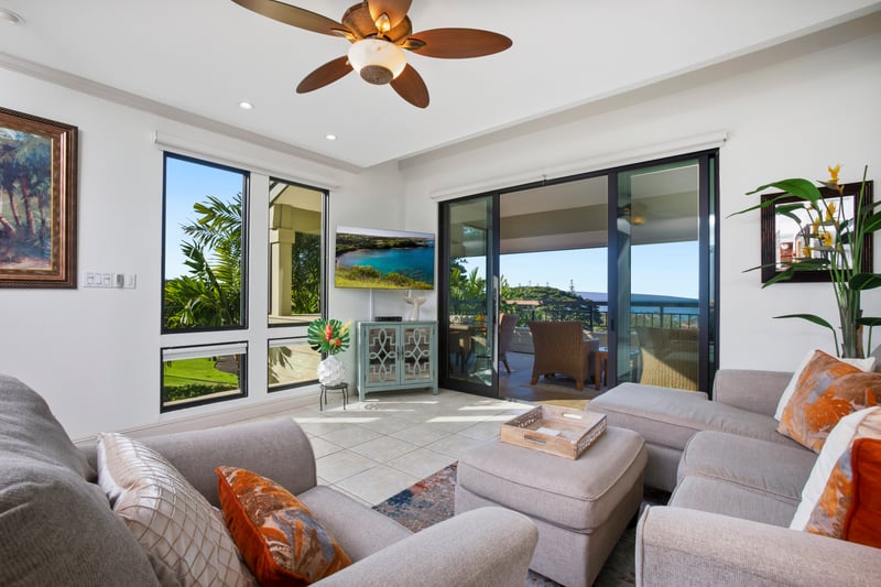 Sunshine pours through glass doors, the sea sparkles in the distance, and the pillows practically beg for a midday nap