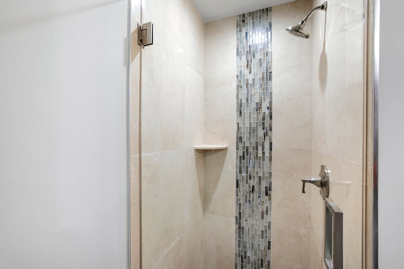 Let the waterfall mosaic tiles guide your eyes from head to toe in this serene shower that’s part spa, part sanctuary
