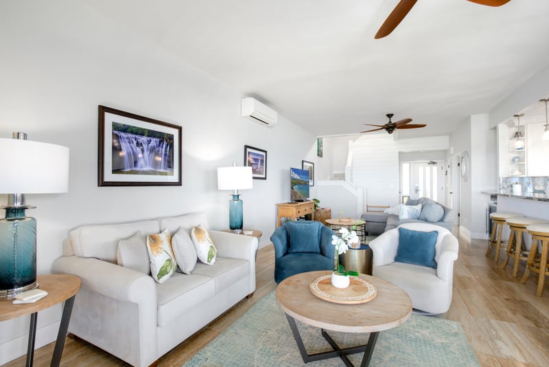 Crisp white walls cradle bursts of sea-glass blue, as woven textures whisper stories of breeze-swept mornings