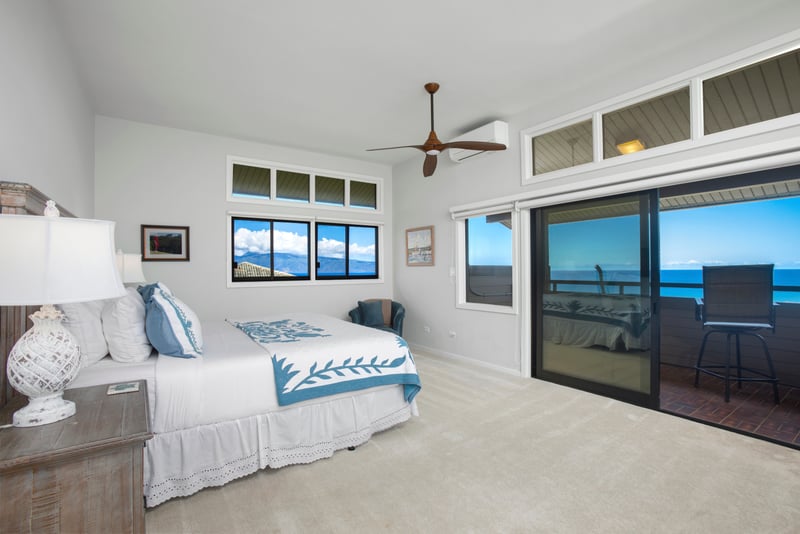 A hand-carved bed, tropical quilt, and walls washed in light — your personal cloud of calm and charm awaits