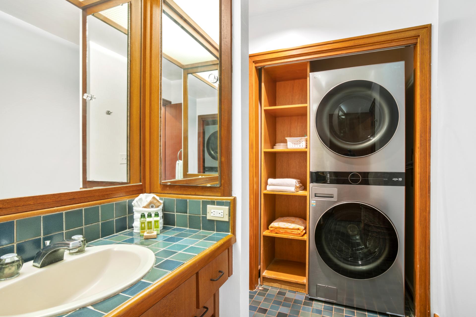 Convenience meets design with in-unit laundry, neatly tucked into a warm, wood-accented nook