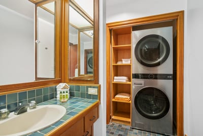 Convenience meets design with in-unit laundry, neatly tucked into a warm, wood-accented nook KRV-514