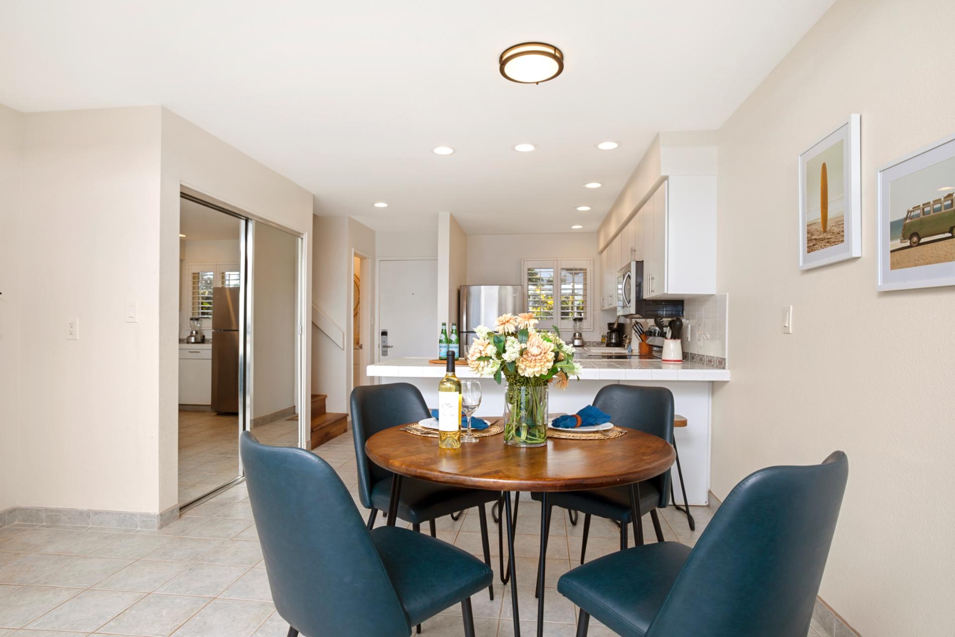 Dine beside ocean blues in this airy nook where sleek chairs, fresh florals, and seaside sunshine set the tone   