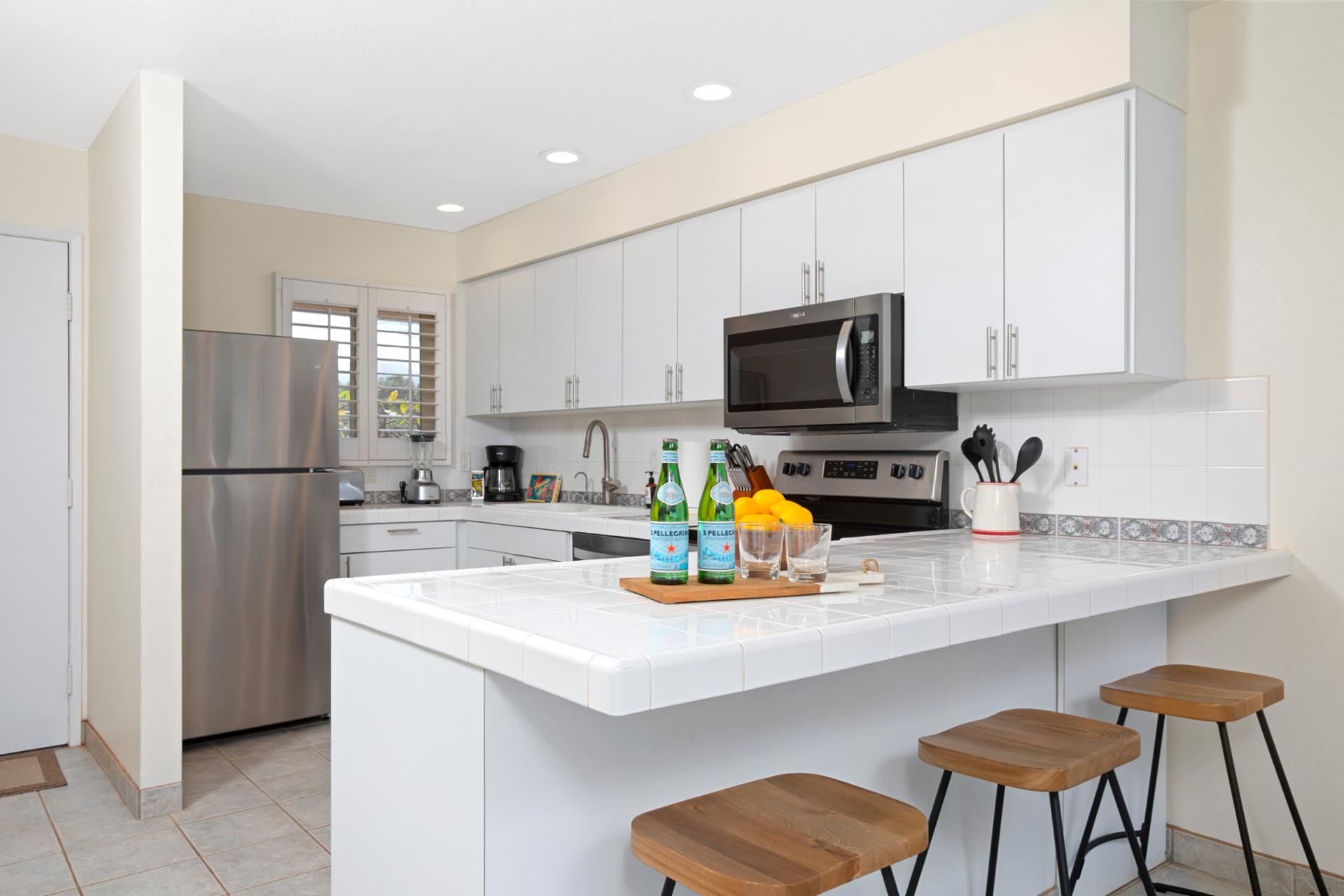 Whitewashed wonder with stainless sparkle—this kitchen is crisp, coastal, and perfect for sunset-seasoned bites   