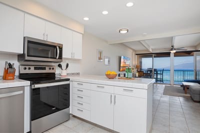 Crisp white cabinets and breezy light make this kitchen feel like a cloud where recipes float and flavors sing