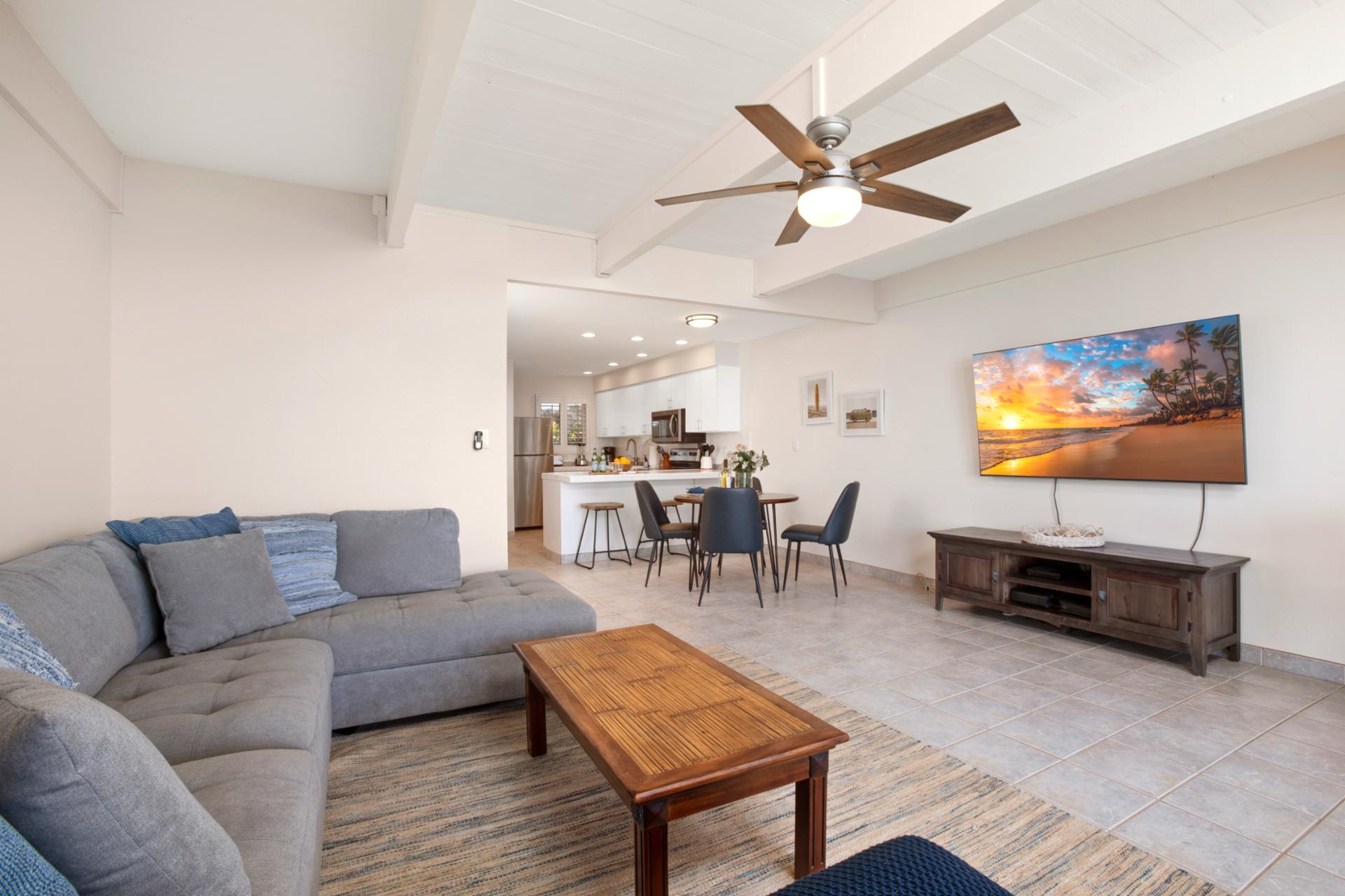 Spacious and simple, this open-plan retreat features plush seating, beachy hues, and room to gather or sprawl   