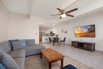 Spacious and simple, this open-plan retreat features plush seating, beachy hues, and room to gather or sprawl