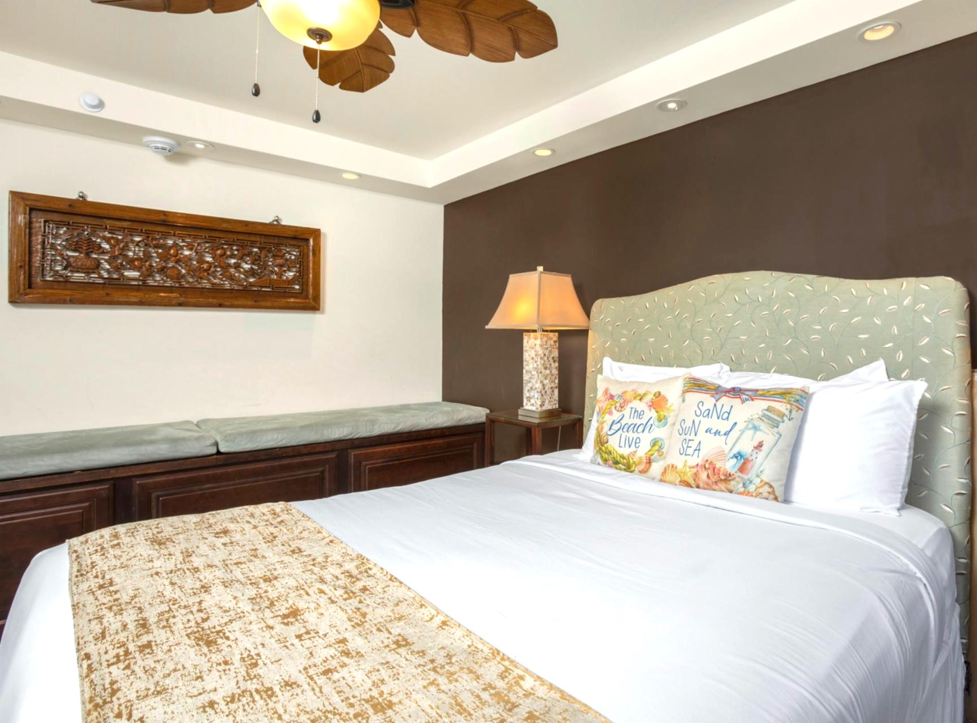  A palm-leaf ceiling fan swirls gentle breezes above the queen bed, like nature itself waving you to sleep