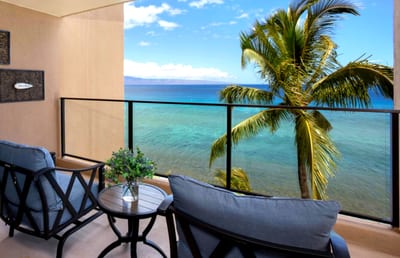 This oceanfront lanai offers front-row views of swaying palms, turquoise waters, and the sound of pure serenity