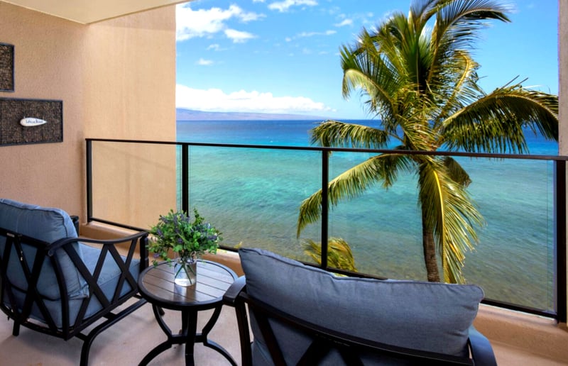 This oceanfront lanai offers front-row views of swaying palms, turquoise waters, and the sound of pure serenity