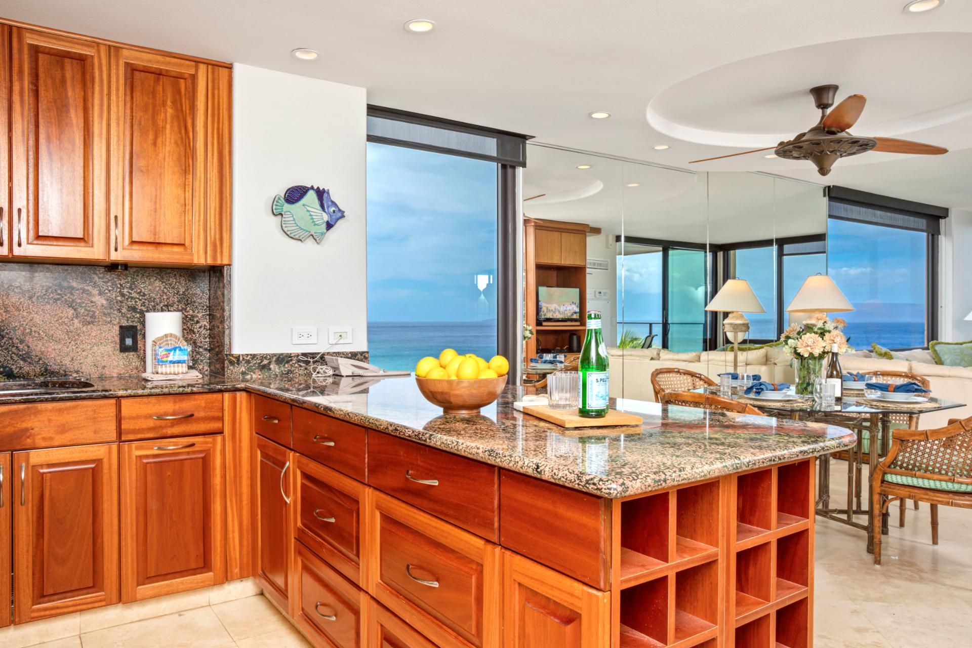 Cook with a view in this gourmet kitchen featuring island seating and ocean backdrop