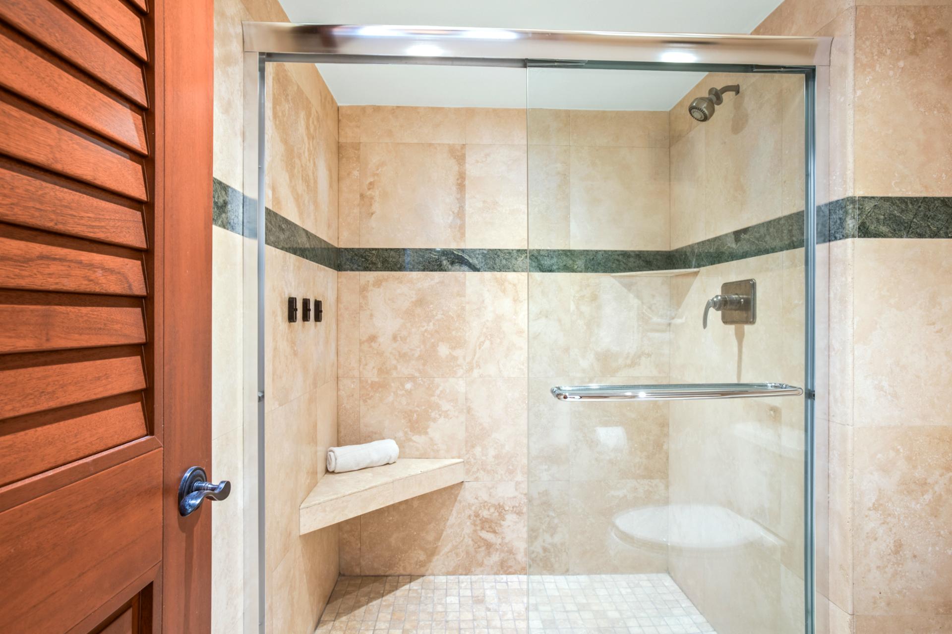 Inviting walk-in shower and natural stone accents for a relaxing rinse