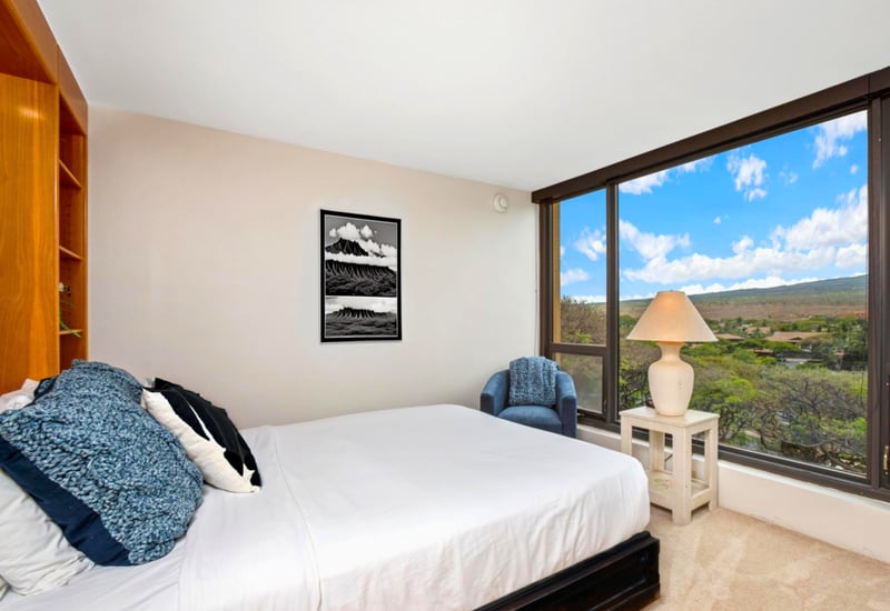 Bright and comfortable guest bedroom featuring a queen bed and wide, spacious windows MAH-719