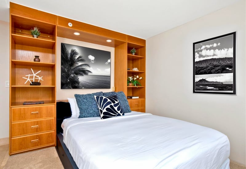 A cozy retreat featuring a queen bed for extra guests with thoughtful touches and island artwork MAH-719