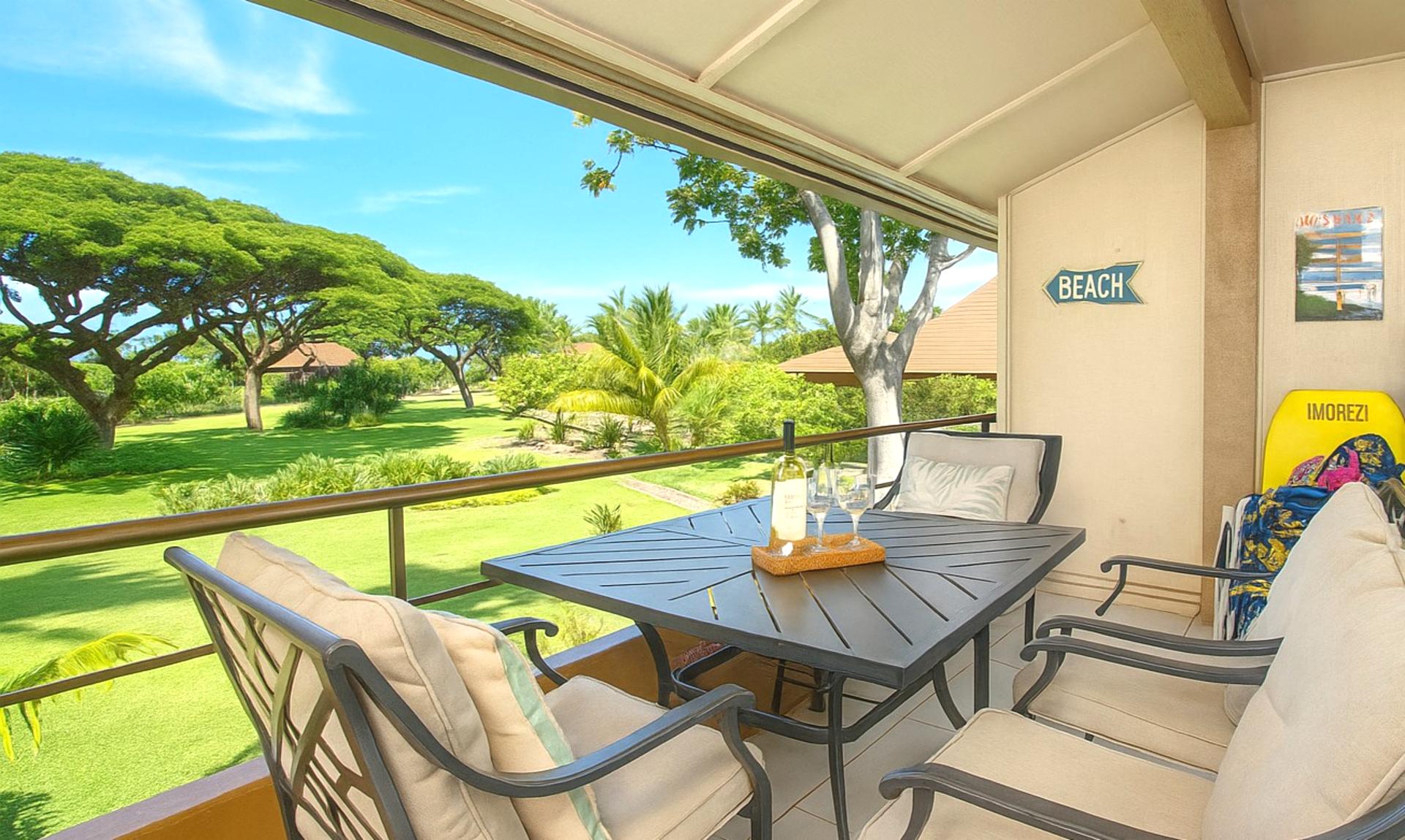 Unwind on this breezy lanai with plush seating, shaded comfort, and peaceful views of manicured lawns and monkeypod trees MKV-B247