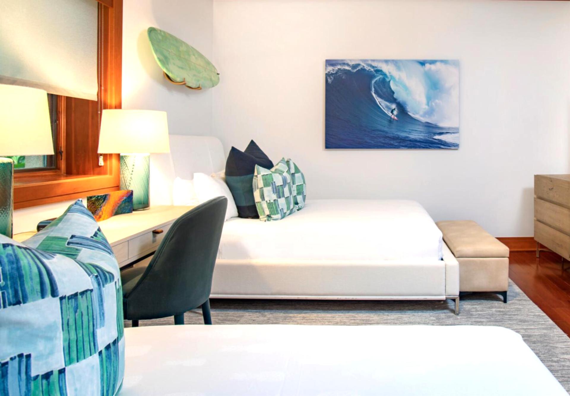 Twin beds with crisp white linens and bold accent pillows offer comfort with a splash of coastal flair MON-1205