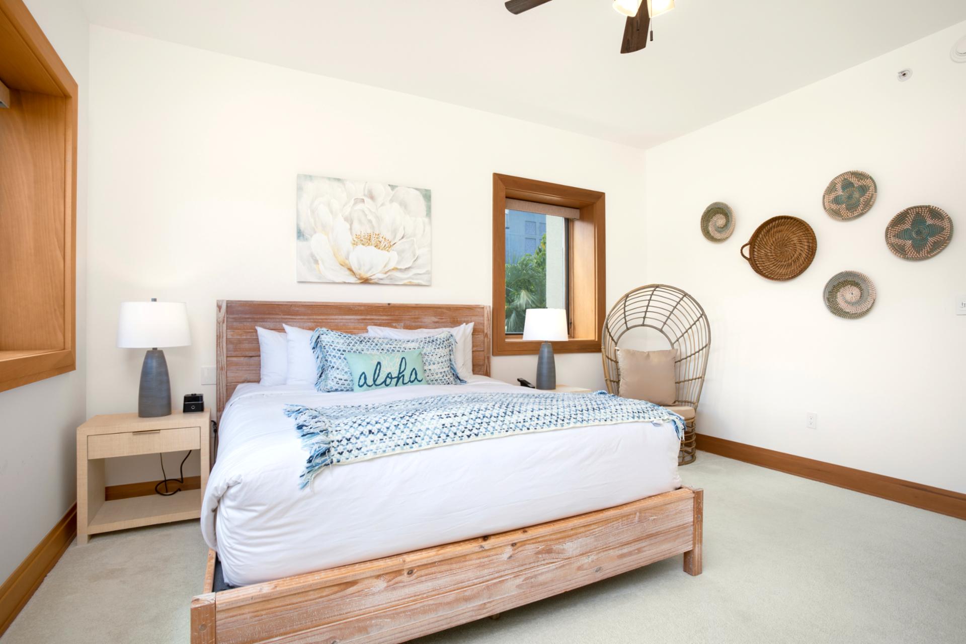    Sunlight pours through picture windows, casting a warm glow across soft linens and gentle ocean-toned accents