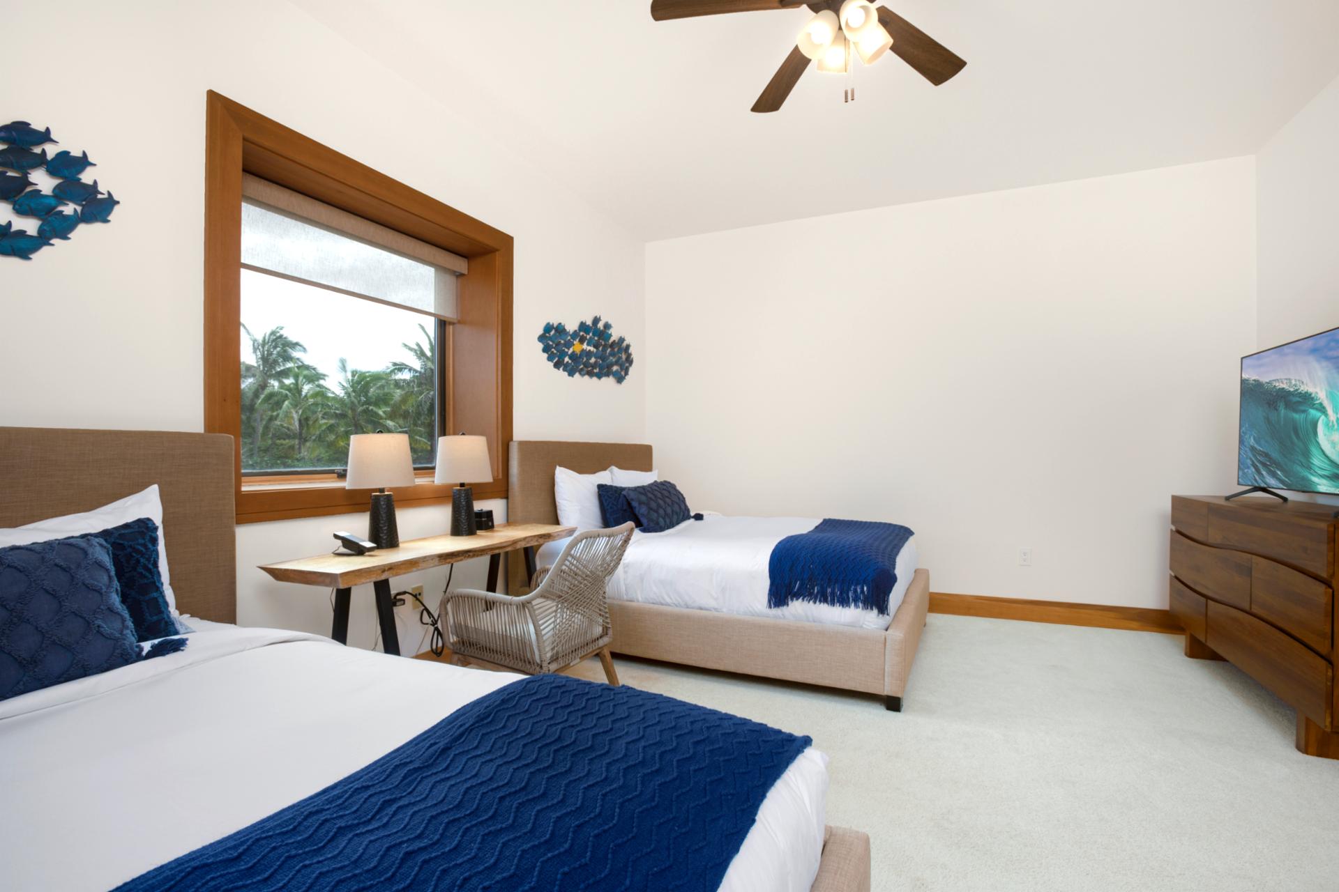 A central window draws the eye with its framed countryside view, offering a tranquil backdrop for serene rest   