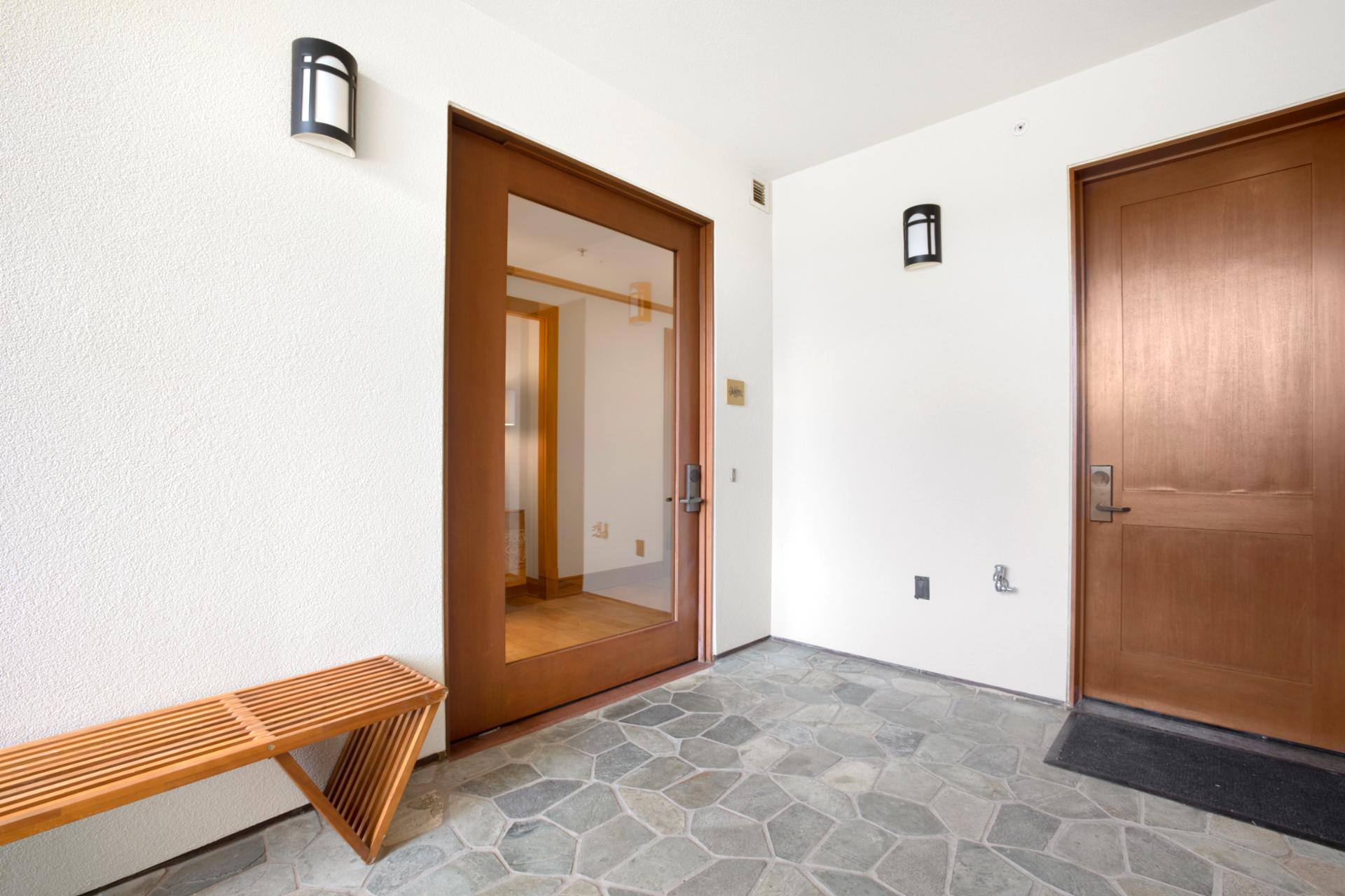 A peaceful, polished welcome—this private entrance blends natural textures and modern design for a refined first impression   