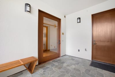 A peaceful, polished welcome—this private entrance blends natural textures and modern design for a refined first impression MON-6301