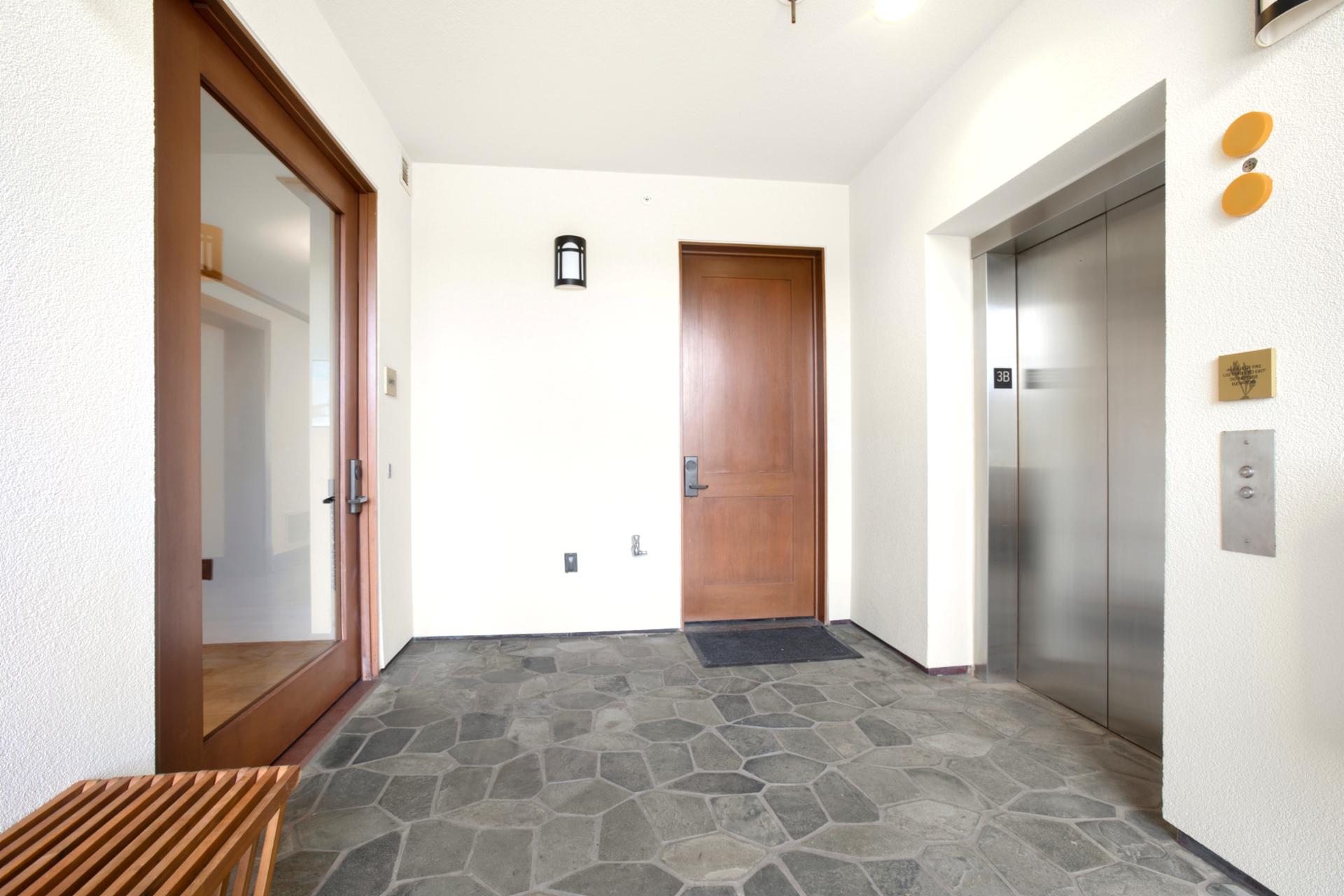 Arrive through a serene stone-tiled entryway where warm wood finishes and clean lines set a calming tone for your stay   