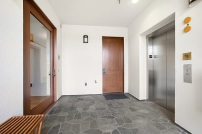 Arrive through a serene stone-tiled entryway where warm wood finishes and clean lines set a calming tone for your stay MON-6301