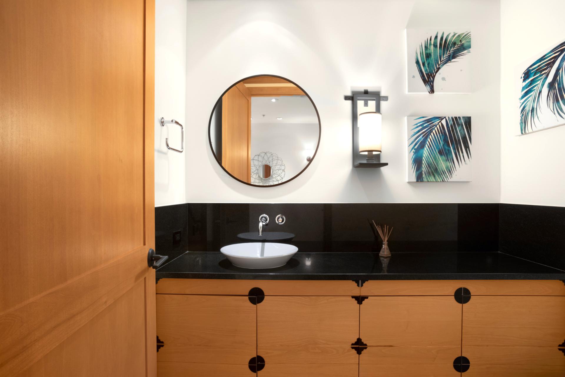   Step into this serene powder room where natural wood, coastal touches, and soft lighting create a calming retreat 