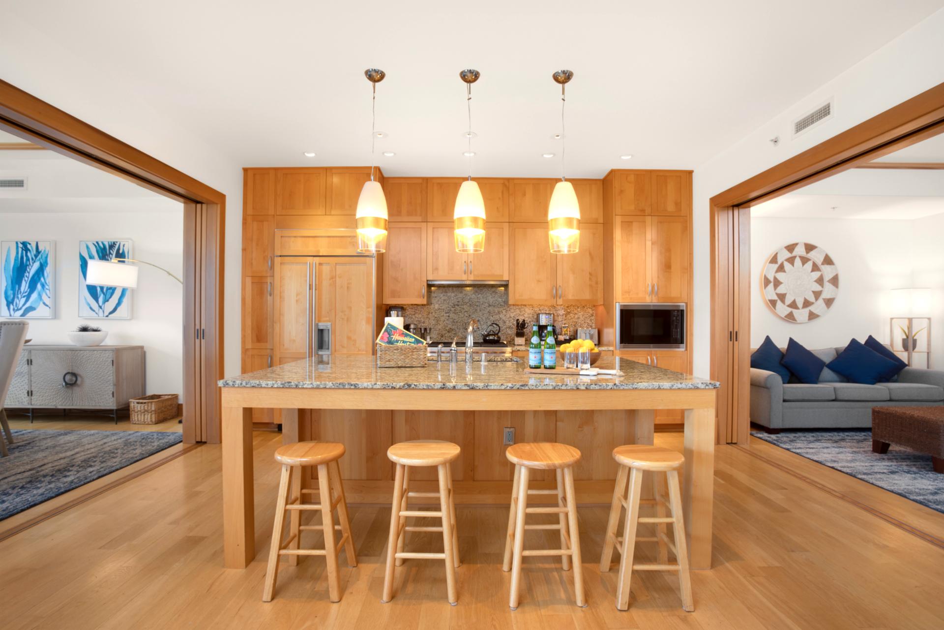 Pendant lights dangle like cheerful lemon drops above a kitchen where joy is clearly part of the recipe   