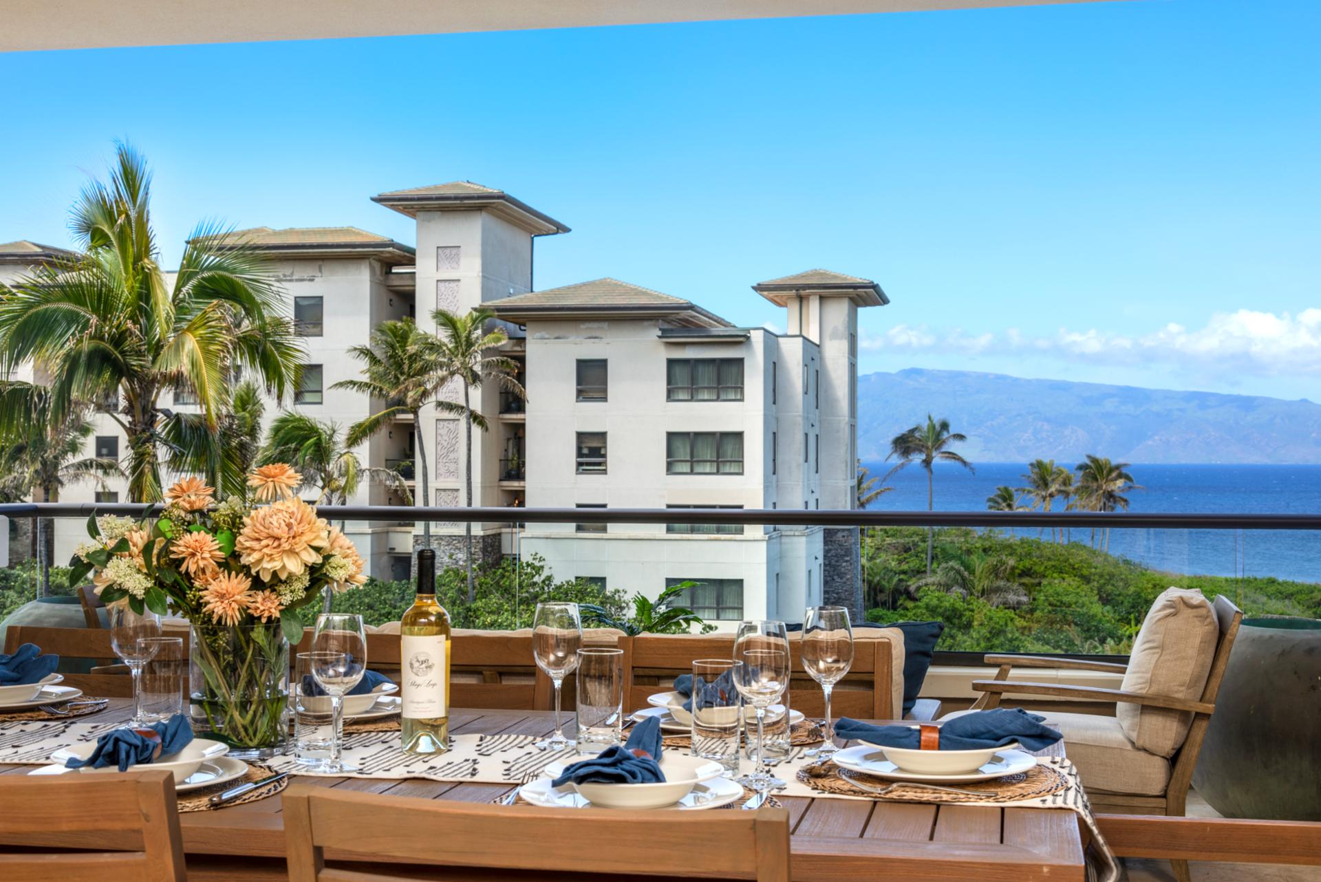 Dine beneath open skies where soft ocean blues meet lush palms and modern elegance flows from kitchen to coastline   