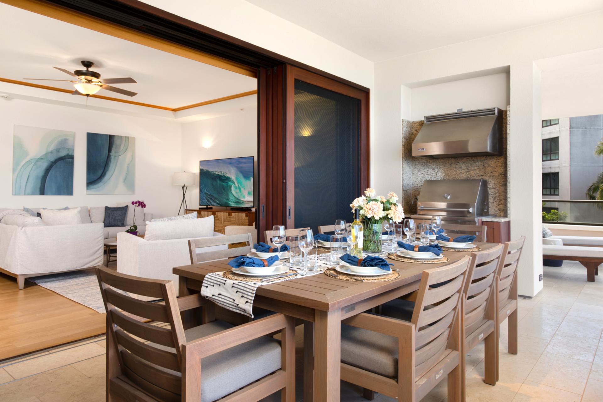 Gather around this beautifully set table, where golden light spills in and the ocean horizon winks beyond the palms   