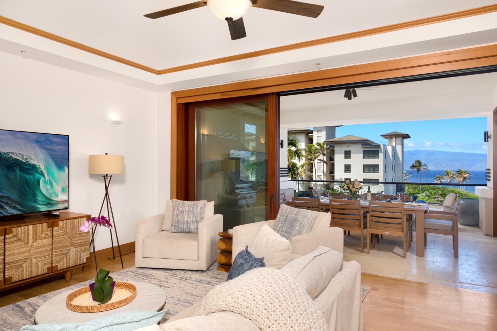With soft hues, plush seating, and the sea sparkling beyond the glass, this living room redefines relaxation   