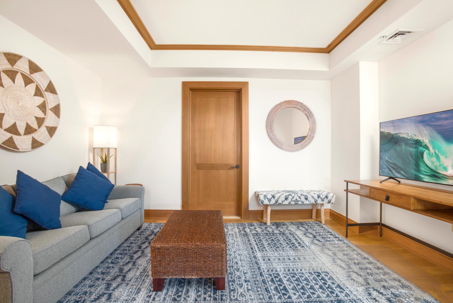    A cozy coastal den designed for relaxation—complete with plush seating, warm wood tones, and a calming island palette