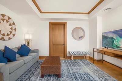 A cozy coastal den designed for relaxation—complete with plush seating, warm wood tones, and a calming island palette MON-6301