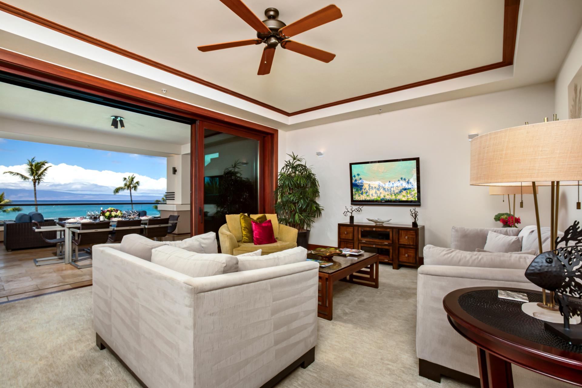 Spacious living room with full ocean views opens directly onto the lanai