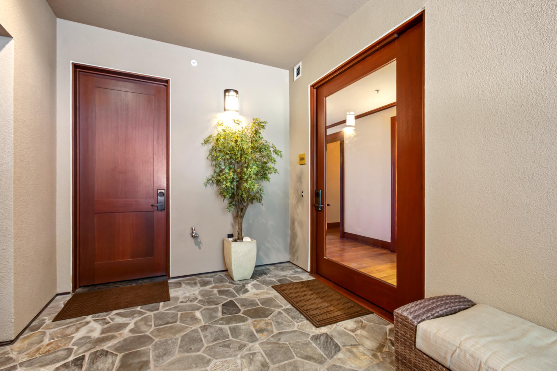 Step into your Maui escape through this inviting entryway with warm wood and natural stone